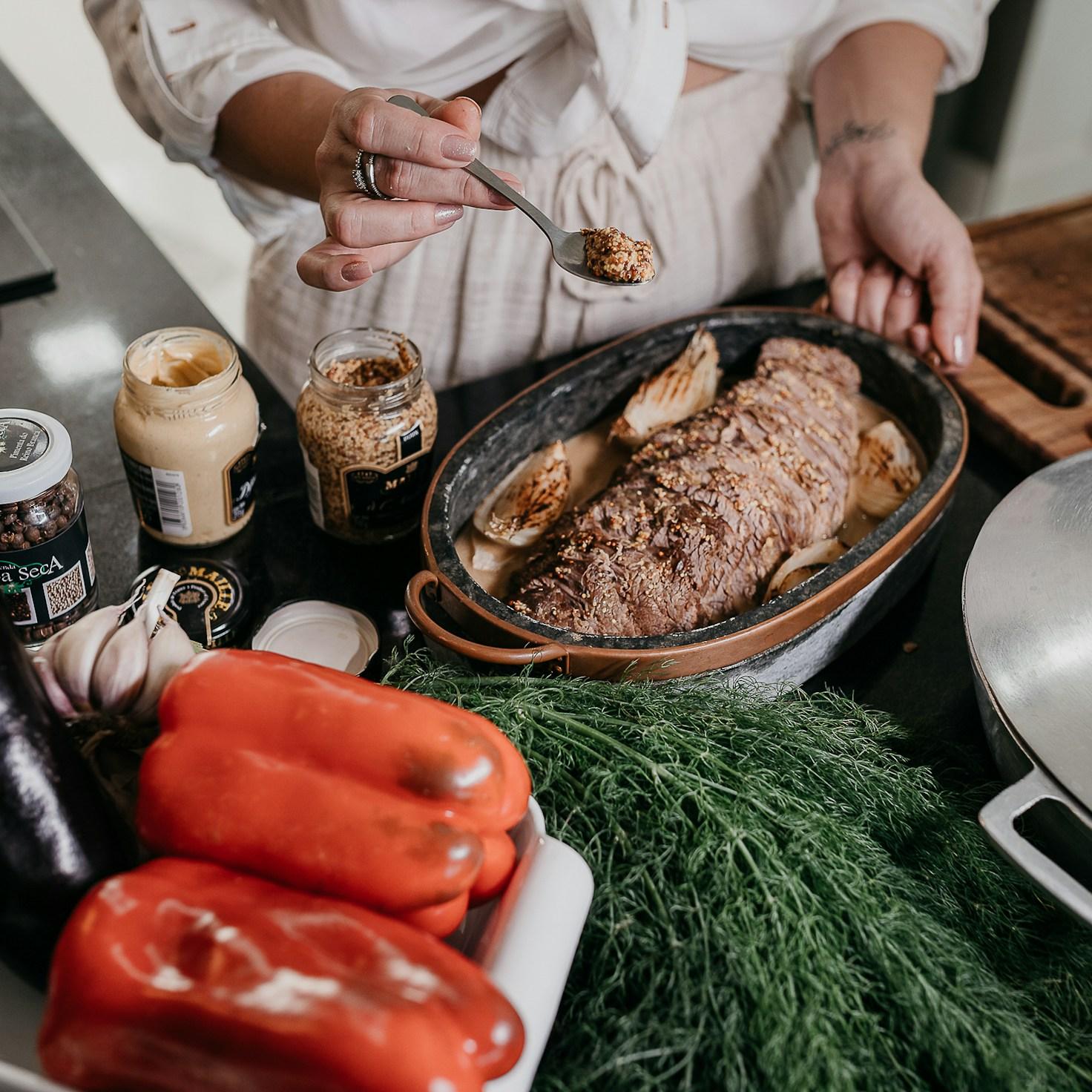 Community members collaborating in a modern kitchen space, exchanging recipes and cooking techniques